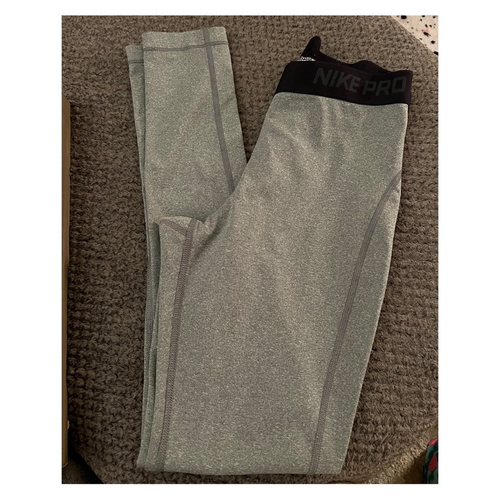NIKE Pro dri-fit leggings size medium. Banded top with logo- tapered leg.